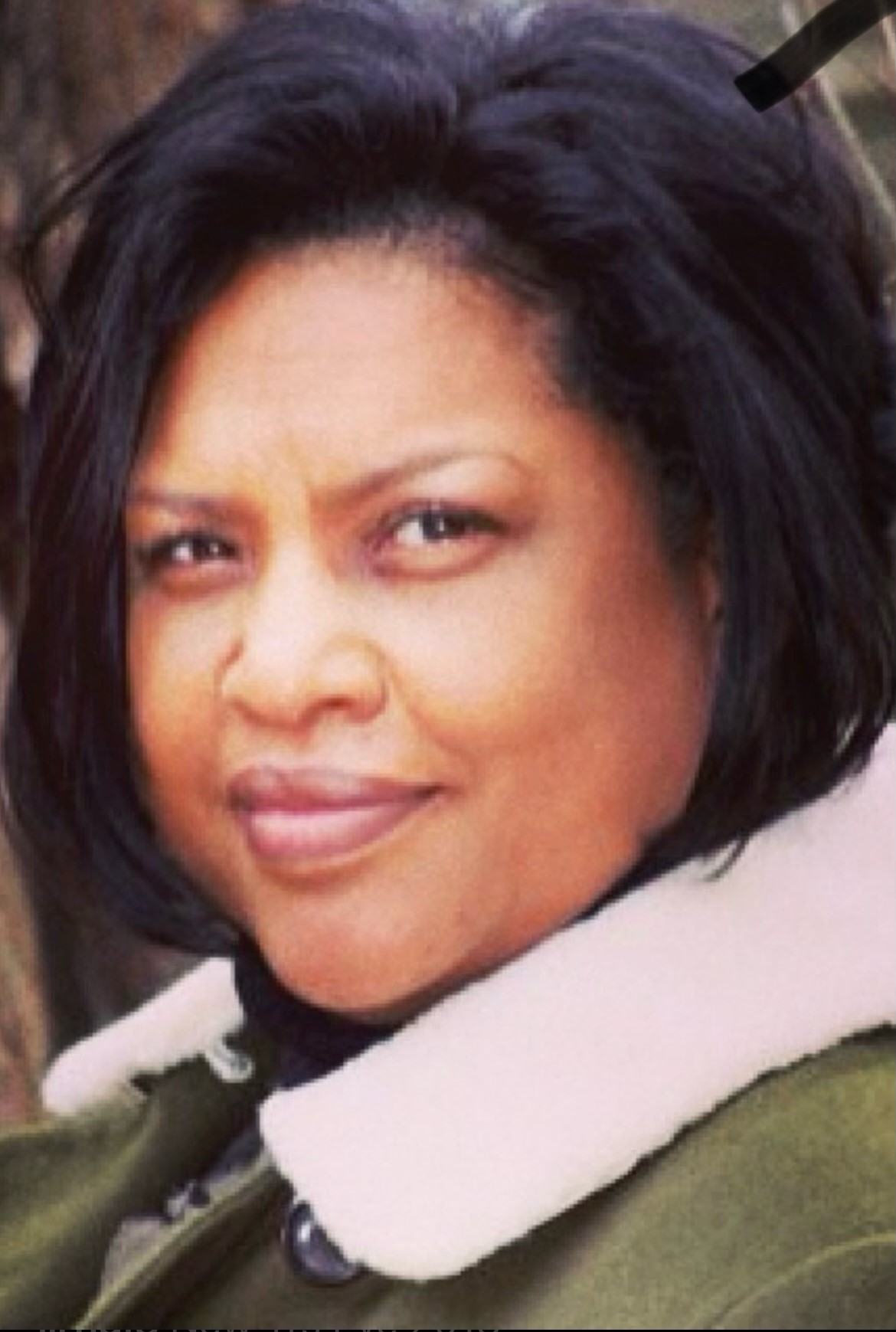 Lisa Randolph in a green jacket with a white collar